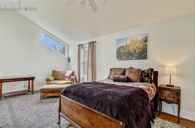 bedroom featuring baseboards, a ceiling fan, and wood finished floors