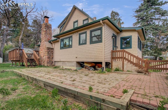 back of property with a chimney