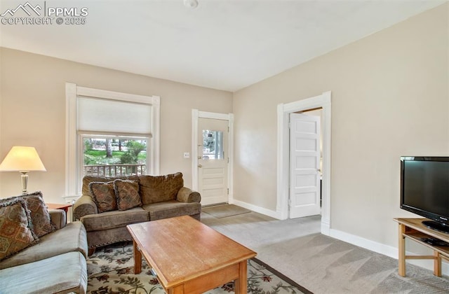 carpeted living room with baseboards