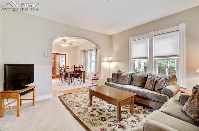 living room featuring arched walkways and baseboards