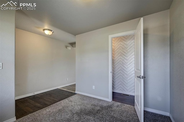 unfurnished bedroom with baseboards and carpet
