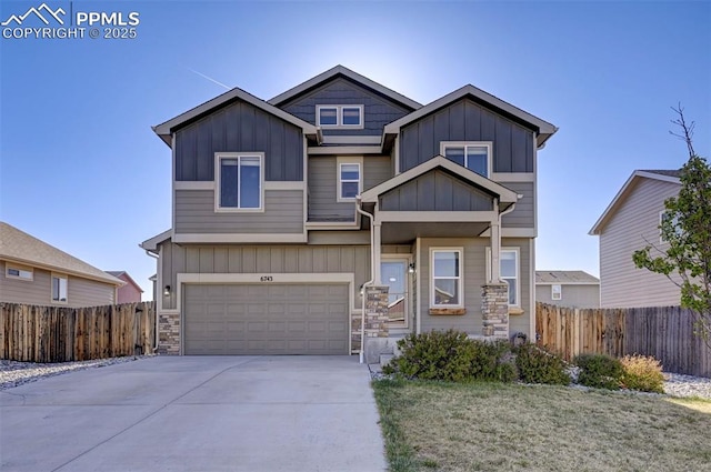 craftsman house with an attached garage, board and batten siding, driveway, and fence