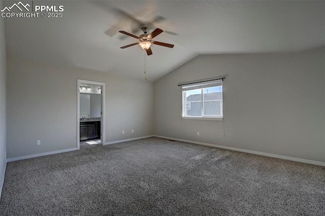 carpeted spare room with lofted ceiling, baseboards, and a ceiling fan