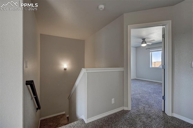 stairway with baseboards, a ceiling fan, and carpet