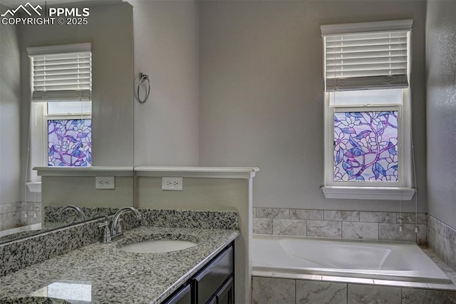 full bath with vanity and a bath