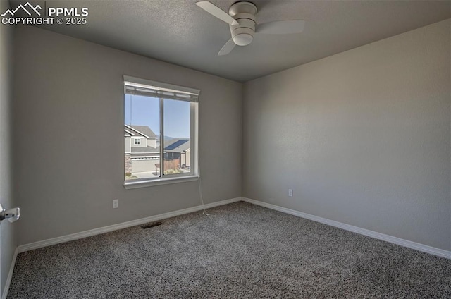 unfurnished room with a ceiling fan, carpet flooring, visible vents, and baseboards