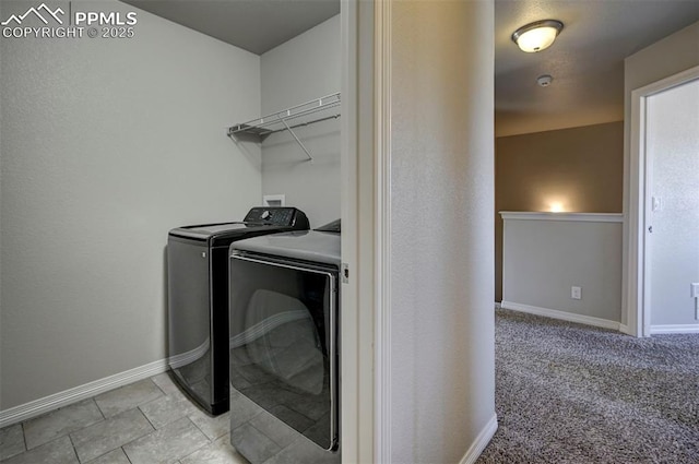 laundry area with baseboards, laundry area, and washer and dryer