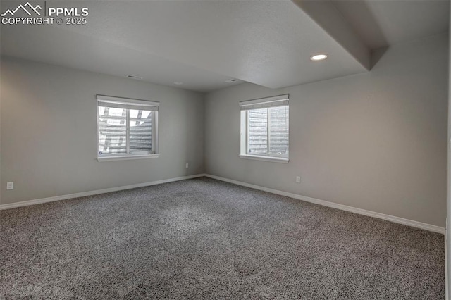 carpeted empty room with a wealth of natural light, baseboards, and recessed lighting