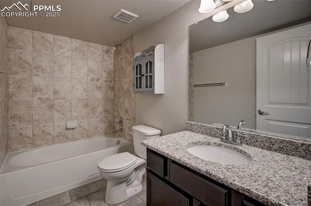 bathroom featuring toilet, vanity, visible vents, tile patterned flooring, and bathing tub / shower combination