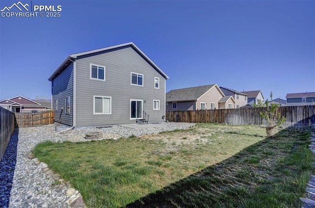 back of property featuring a yard, a patio area, entry steps, and a fenced backyard