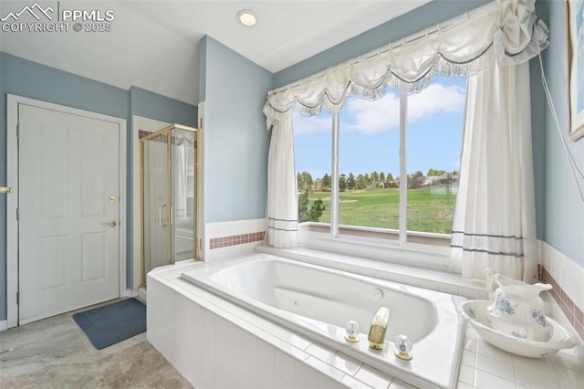 bathroom with a stall shower and a tub with jets