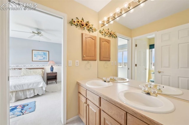 ensuite bathroom featuring double vanity and a ceiling fan