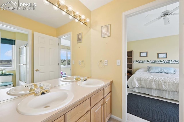 full bath featuring ensuite bath, double vanity, a shower with door, and a ceiling fan