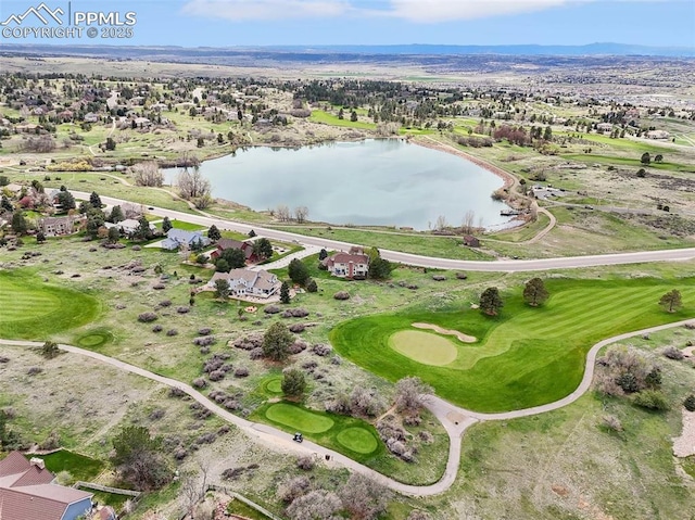 aerial view of residential area with a large body of water and a golf course