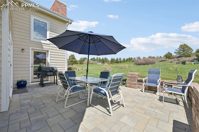 view of patio / terrace featuring outdoor dining space and a grill