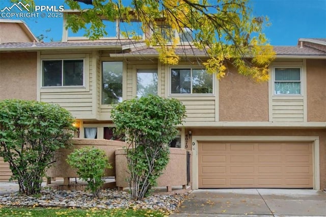 4070 Autumn Heights Dr Unit D, Colorado Springs, CO 80906 - view of front facade featuring concrete driveway, a garage, and stucco siding