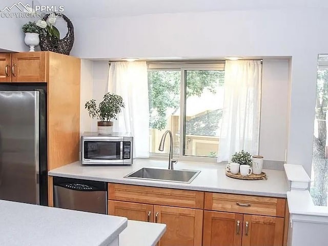 4070 Autumn Heights Dr Unit D, Colorado Springs, CO 80906 - kitchen featuring light countertops, appliances with stainless steel finishes, a healthy amount of sunlight, and a sink