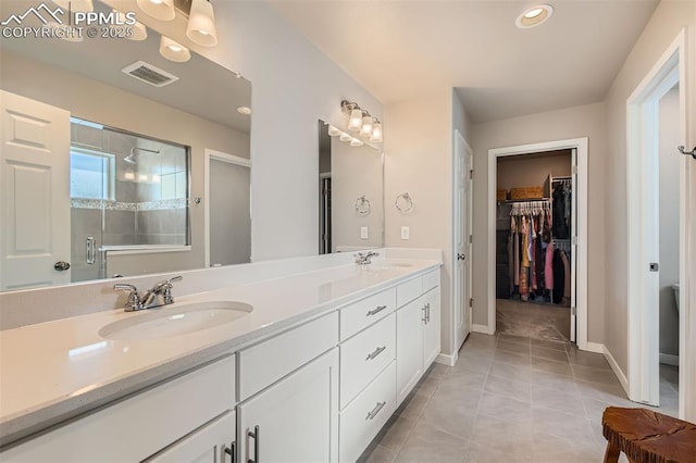 5905 Longford Way, Colorado Springs, CO 80927 - full bathroom with double vanity, visible vents, a stall shower, and a sink