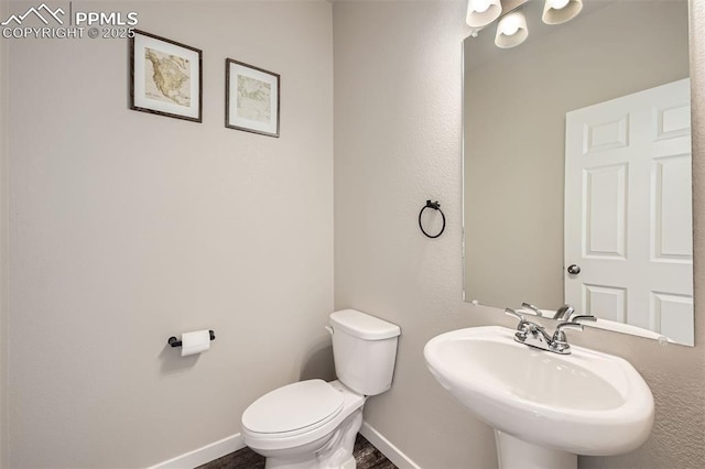 5905 Longford Way, Colorado Springs, CO 80927 - bathroom featuring baseboards, toilet, and a sink