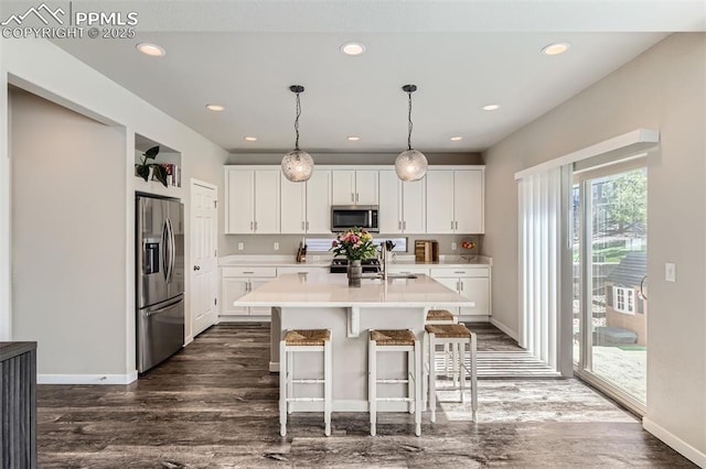 5905 Longford Way, Colorado Springs, CO 80927 - kitchen featuring white cabinets, light countertops, stainless steel appliances, and dark wood-style floors