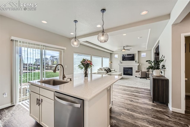 5905 Longford Way, Colorado Springs, CO 80927 - kitchen featuring a sink, a healthy amount of sunlight, dishwasher, a ceiling fan, and a glass covered fireplace