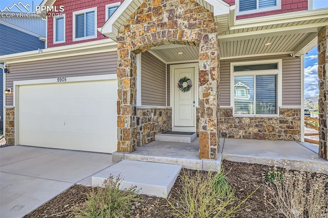 5905 Longford Way, Colorado Springs, CO 80927 - property entrance with concrete driveway, an attached garage, and stone siding