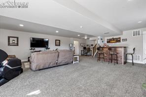 10150 Bracknell Pl, Peyton, CO 80831 - living room with a dry bar and recessed lighting