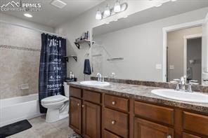 10150 Bracknell Pl, Peyton, CO 80831 - full bath with toilet, double vanity, and shower / bath combo