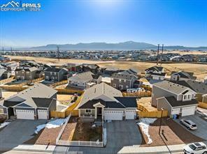 10150 Bracknell Pl, Peyton, CO 80831 - aerial view of residential area with a mountain backdrop