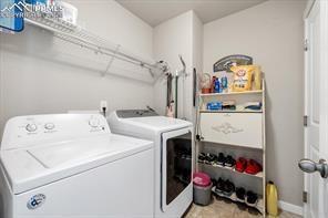 10150 Bracknell Pl, Peyton, CO 80831 - washroom featuring separate washer and dryer and baseboards