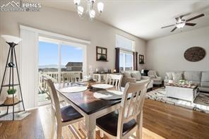 10150 Bracknell Pl, Peyton, CO 80831 - dining room featuring wood finished floors, a chandelier, and ceiling fan