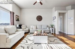 10150 Bracknell Pl, Peyton, CO 80831 - living area featuring dark wood finished floors and ceiling fan