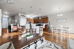 10150 Bracknell Pl, Peyton, CO 80831 - living area with wood finished floors and a chandelier