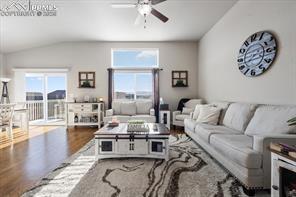 10150 Bracknell Pl, Peyton, CO 80831 - living room with a ceiling fan, wood finished floors, and vaulted ceiling