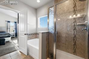 10150 Bracknell Pl, Peyton, CO 80831 - full bathroom with a garden tub, a shower stall, and tile patterned floors
