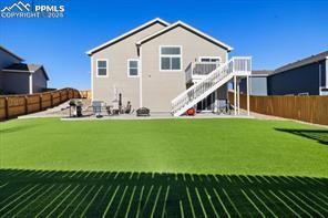 10150 Bracknell Pl, Peyton, CO 80831 - rear view of house with stairway