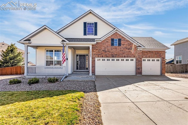 12383 Pine Valley Cir, Peyton, CO 80831 - traditional home with driveway, a porch, brick siding, and an attached garage