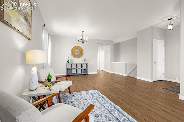 12383 Pine Valley Cir, Peyton, CO 80831 - living area with wood finished floors, a chandelier, and baseboards