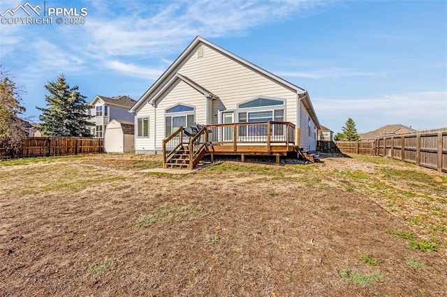 12383 Pine Valley Cir, Peyton, CO 80831 - rear view of property featuring a fenced backyard, a wooden deck, a storage shed, and an outdoor structure