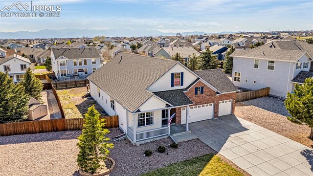 12383 Pine Valley Cir, Peyton, CO 80831 - view of front of house featuring a residential view, concrete driveway, fence, covered porch, and brick siding
