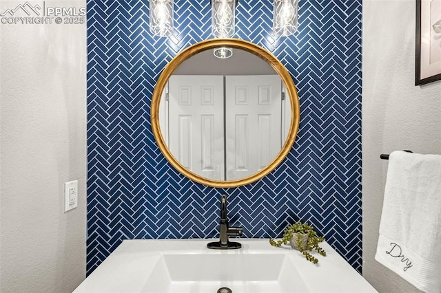 12383 Pine Valley Cir, Peyton, CO 80831 - bathroom featuring a sink, tile walls, and decorative backsplash