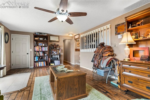 17090 Forest Green Way, Elbert, CO 80106 - living area featuring a textured ceiling, hardwood / wood-style flooring, and a ceiling fan
