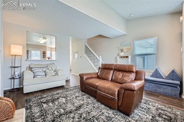 6640 Oakwood Blvd, Colorado Springs, CO 80923 - living room with wood finished floors, stairs, a textured ceiling, and baseboards