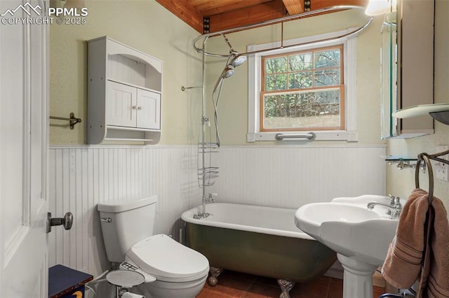 18 Fountain Pl, Manitou Springs, CO 80829 - bathroom with a wainscoted wall, a bathtub, toilet, and tile patterned floors