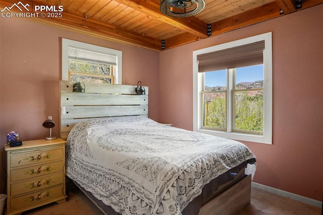 18 Fountain Pl, Manitou Springs, CO 80829 - bedroom with wooden ceiling, multiple windows, beamed ceiling, carpet flooring, and baseboards
