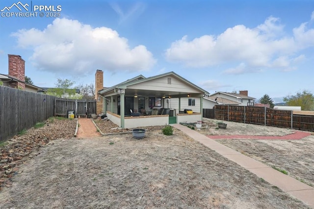 5050 Bunk House Ln, Colorado Springs, CO 80917 - back of house featuring a fenced backyard and a chimney