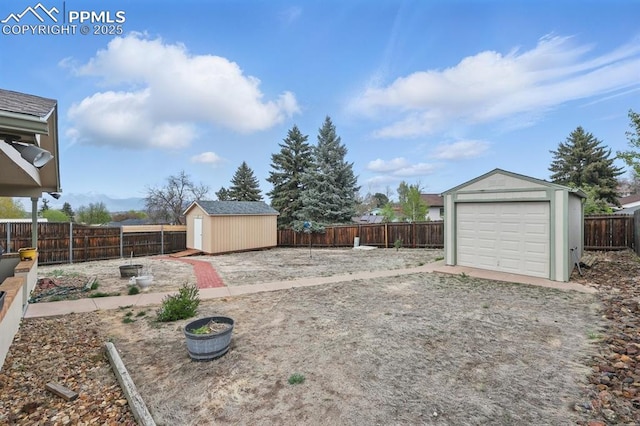 5050 Bunk House Ln, Colorado Springs, CO 80917 - fenced backyard featuring an outdoor structure, a storage shed, and a garage
