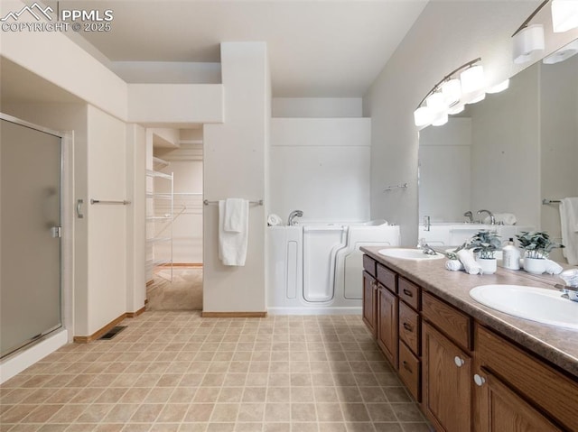7049 Vasalias Hts, Colorado Springs, CO 80923 - full bathroom featuring a sink, double vanity, a garden tub, and a shower stall