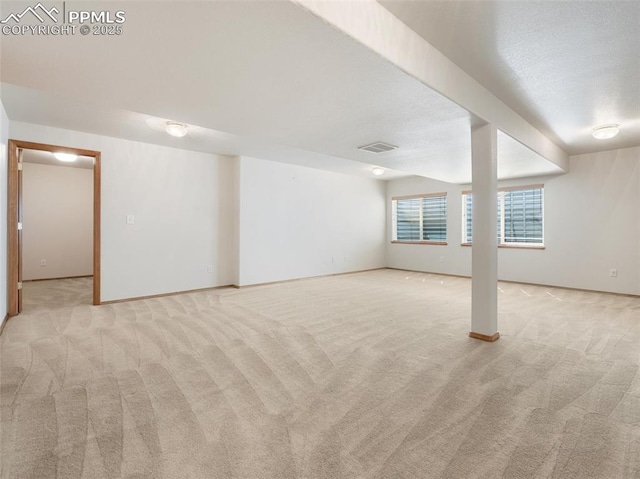7049 Vasalias Hts, Colorado Springs, CO 80923 - below grade area with light colored carpet, visible vents, and baseboards