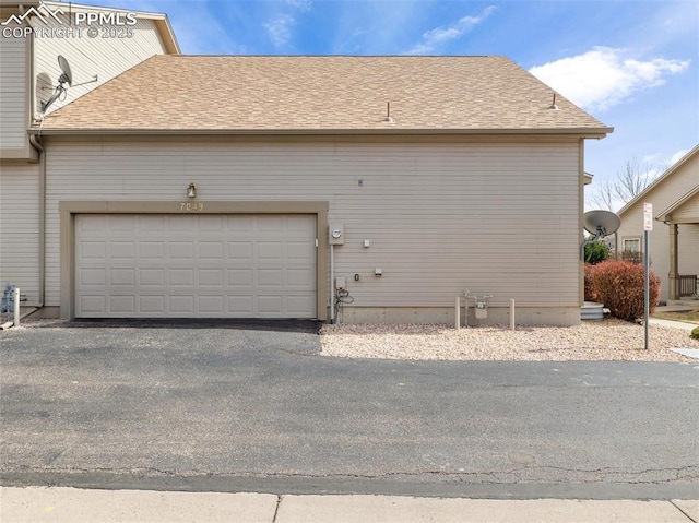 7049 Vasalias Hts, Colorado Springs, CO 80923 - garage with aphalt driveway